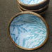 ROUND BOWL WOOD WITH BLUE PLANT ON WHITE