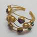 GOLD CUFF WITH CHUNKS OF AMETHYST AND CITRINE