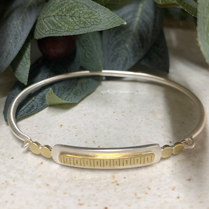 BRACELET WITH LINED BRASS FEATURE